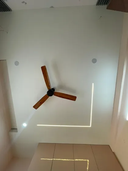 A view of a false ceiling design in a kid's bedroom, featuring an interesting L-shaped profile light. This on-site photo shows how we use lighting as a key architectural element.