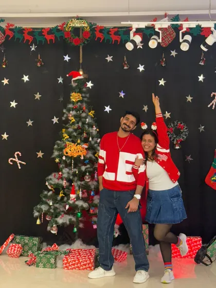 Posing with my partner in our festive outfits. The holiday season is all about joy, love, and of course, dancing.