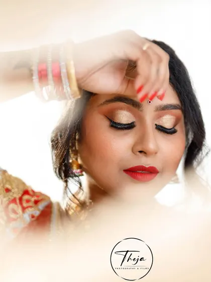 An artistic shot with a soft, dreamy filter, focusing on the beautiful eye makeup and classic red lip.