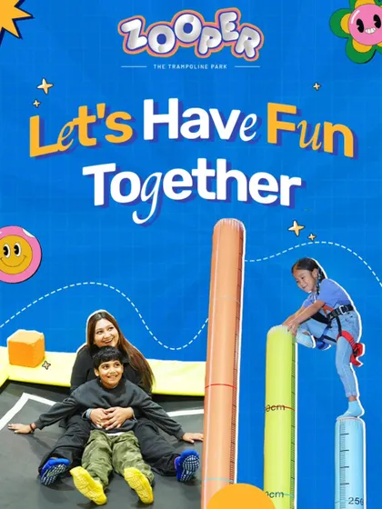 Let's have fun together. Here, a family enjoys different activities, with a young adventurer tackling the climbing pillars while her family bounces below.