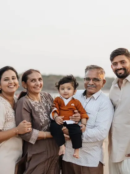 A wonderful multigenerational family photo taken on the beach to celebrate a first birthday.