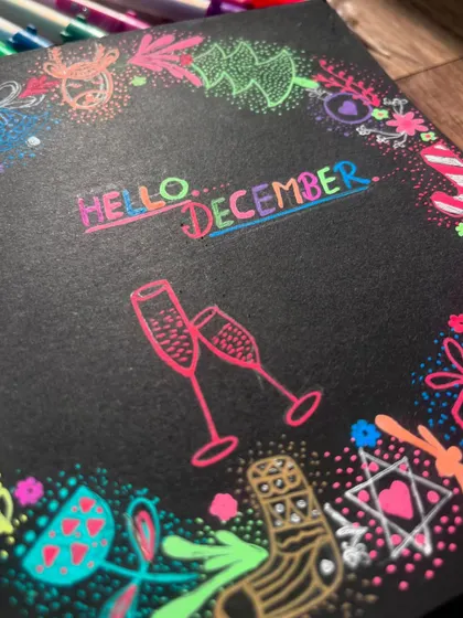 A close-up of the "Hello December" doodle, showing the champagne glasses ready for celebration.