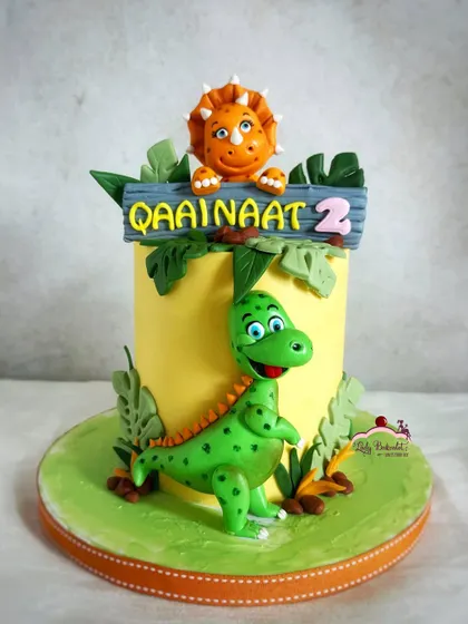 Another angle of this dino-mite cake, showing the cute triceratops and T-rex figures.