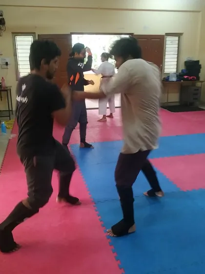 Another moment from a kumite session, showing students exchanging techniques and applying what they have learned in drills.