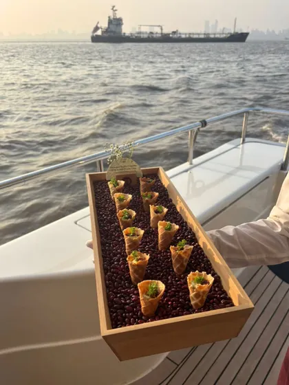 A tray of savory cones being served on a yacht. These bite-sized treats are easy for guests to enjoy while mingling, showcasing our ability to create practical and delicious menus for any venue.