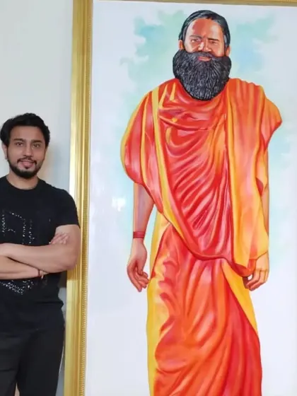 Another life-sized portrait of Swami Ramdev ji, this time in his iconic saffron robes, reflecting his status as a spiritual leader.