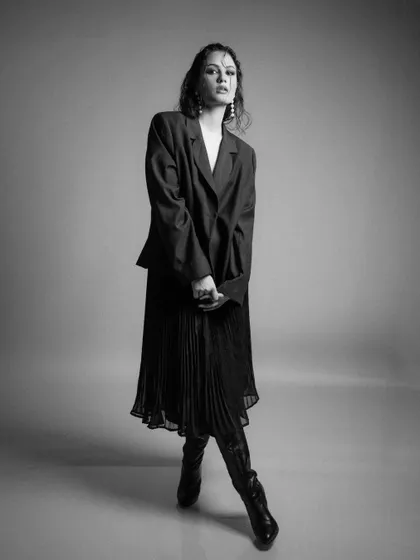 A full-length black and white portrait from 'FLOR', showcasing the complete silhouette.