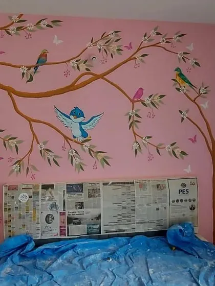 A beautiful mural of colorful birds perched on tree branches against a soft pink background, creating a charming and serene atmosphere in a bedroom.