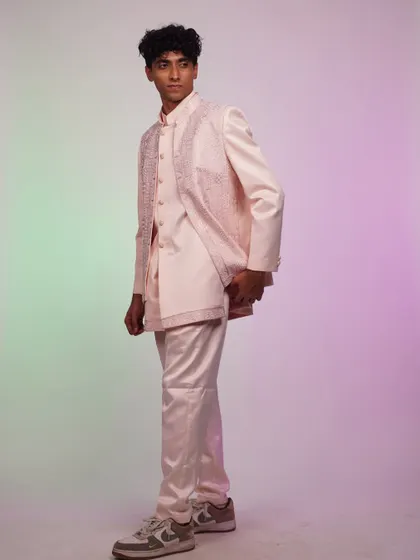 A side view of the pink Indo-western set. The layered look is modern and stylish, perfect for a fashion-forward guy.