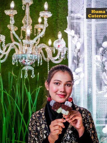 A guest enjoying our unique dango-style dessert skewer, showcasing our innovative approach to sweets.