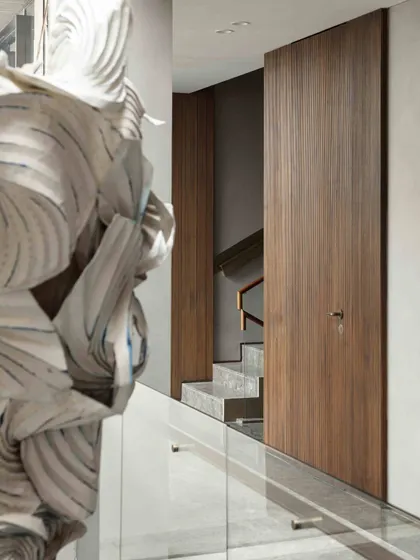 The main staircase at the Bammi Residence, where the journey is punctuated by art. Here, the Shibori and origami installation by Ankon Mitra is visible, infusing the architectural space with meaning and modern craftsmanship.