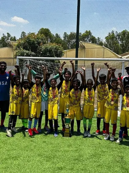 Our U9 team celebrating their Gold Cup championship at the GIG International School tournament.