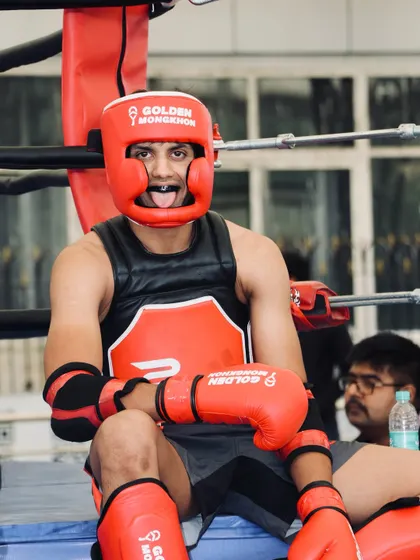 A moment of rest for a Muay Thai champ between rounds. The focus and intensity never waver.