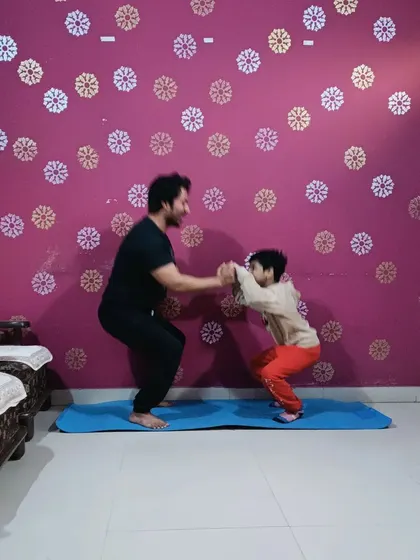Teaching a young student the basics of a bodyweight squat. It's never too early to learn about health and fitness.