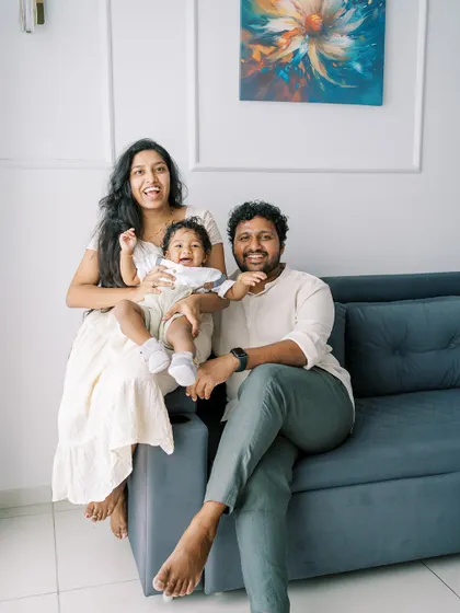 A happy family portrait on the sofa. The laughter and joy are what make this photo so special.