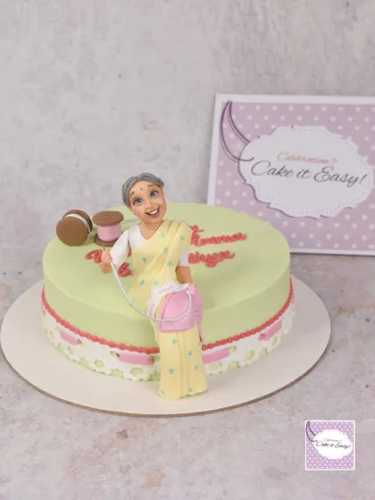 A different angle of the sewing-themed cake, showing the delicate lace detail.