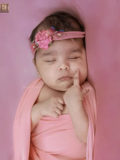 An adorable close-up where the baby is touching her own cheek. These unposed, natural movements are precious to capture.