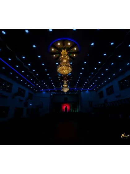 A dramatic silhouette of the couple against a red-lit doorway in a grand, dark hall, showcasing my cinematic style.