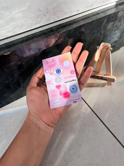 A multi-purpose affirmation card held in hand, with positive messages like "I am healthy" and "I am beautiful." These are great to include in hampers or to use as daily reminders.