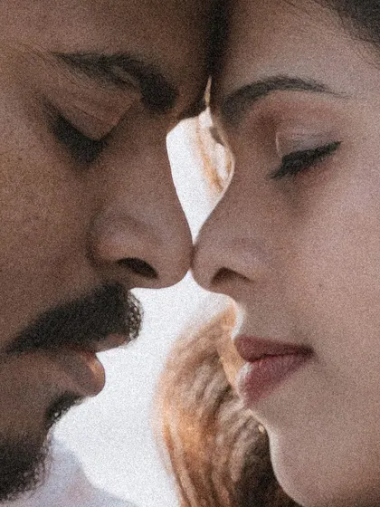 A grainy, artistic close-up of a couple's faces, capturing an intimate and soulful moment.