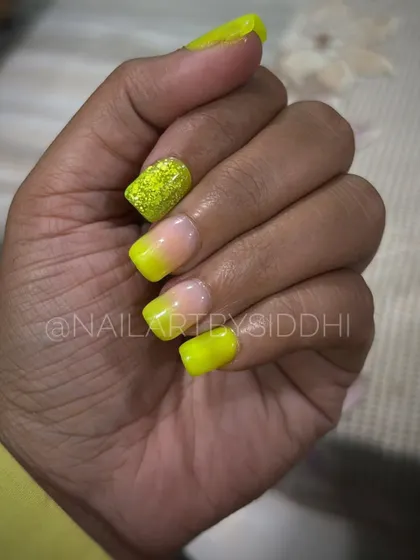 A vibrant neon yellow ombre set, with one nail featuring a full-coverage glitter finish for extra pop.