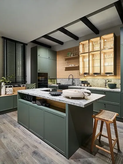 Another vibrant pick from our 2025 novelties, this kitchen in eucalyptus green features smart storage niches and a central island, bringing the essence of nature indoors.