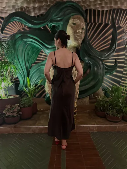 A back view of my brown dress and red heels look. Today is the occasion, so wear the bold heel and step into the dress.