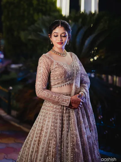 A beautiful, downward-glancing portrait of the bride, showcasing her elegant eye makeup.