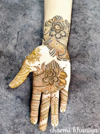 A beautiful example of a modern, artistic mehendi design on a practice sheet. The shading and fine lines create a stunning floral and peacock fusion.