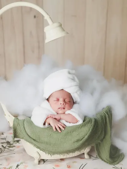 A little spa day, anyone? We create these fun and whimsical scenes, like this one with a baby relaxing in a tiny tub surrounded by fluffy clouds, to make your newborn shoot extra special.
