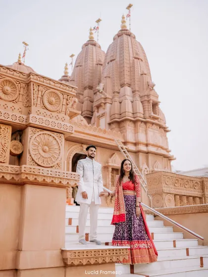 A classic portrait on the temple steps, with the grand structure creating a majestic backdrop for their love story.