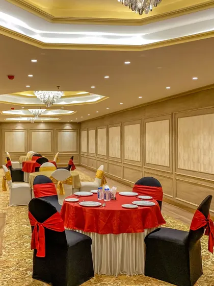 The banquet hall in Bhopal set for a smaller function. The design's neutral palette allows it to be easily adapted for different event themes and color schemes.