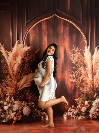 A playful and happy portrait in a casual striped dress. This shot shows that you don't always need a gown to have a beautiful maternity photo.
