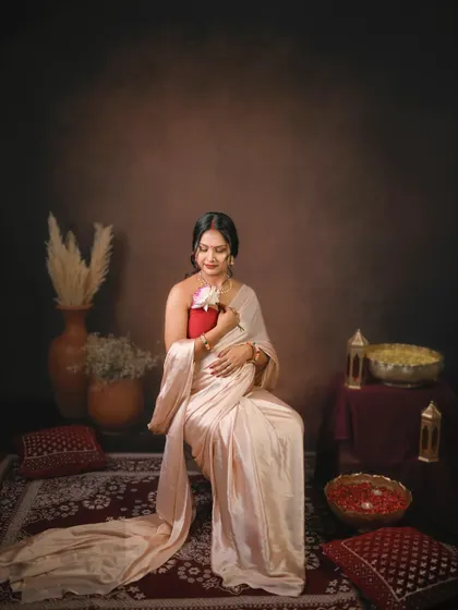 A quiet moment of connection. The mom to be holds a flower to her belly, symbolizing the new life blooming within.