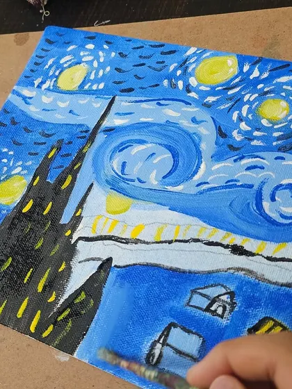 A close-up of the brushstrokes and colors used to recreate the iconic 'Starry Night'.