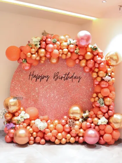 A closer look at the circular shimmer backdrop for the mother-daughter birthday party. The round shape adds a modern touch, while the organic balloon garland in shades of peach and rose gold keeps it soft and celebratory.