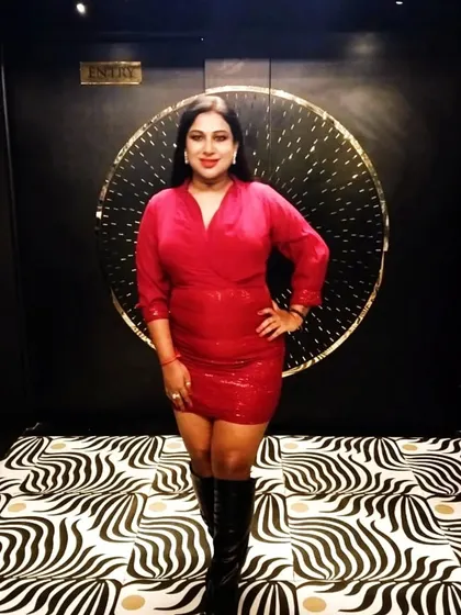 A full-length shot in a red dress and boots, taken at Zozo before my Christmas bash. The zebra-print floor and gold accents made for a very stylish backdrop.