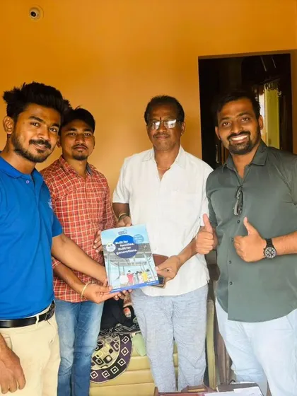 Our team with a customer holding our "Built for Generations" booklet.