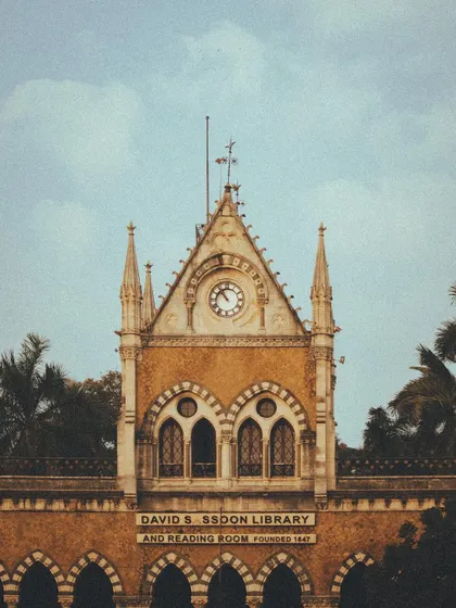 The David Sassoon Library, another beautiful example of Mumbai's heritage architecture, framed against a clear blue sky.