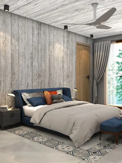 The room is designed with clean lines and uncluttered spaces, featuring a blue upholstered bed and a patterned rug that adds a touch of vibrancy.