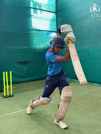 A young player practices his high-elbow drive in the indoor nets, a fundamental shot for any aspiring top-order batsman.