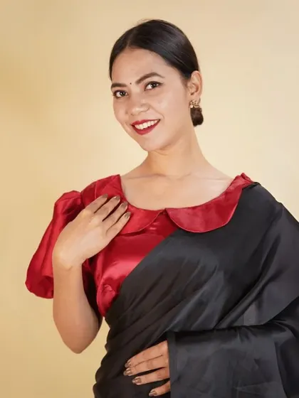 A red satin blouse with a contrasting Peter Pan collar and puffed sleeves. This design is both fun and elegant.
