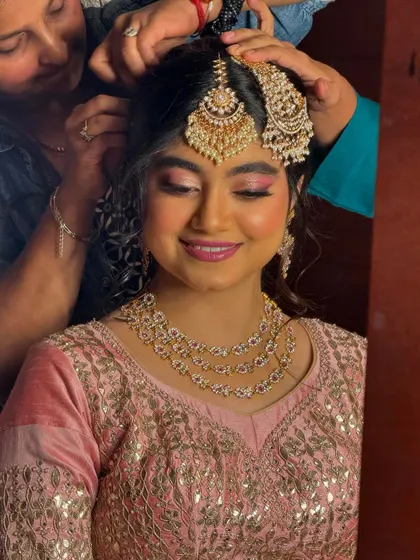 A duplicate of the behind-the-scenes shot, highlighting the collaborative process of getting a bride ready.