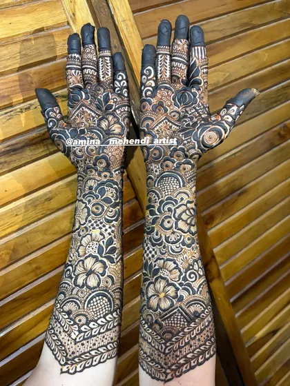 A full-coverage engagement design with dark, solid fingertips that make the intricate patterns on the hands and arms pop.