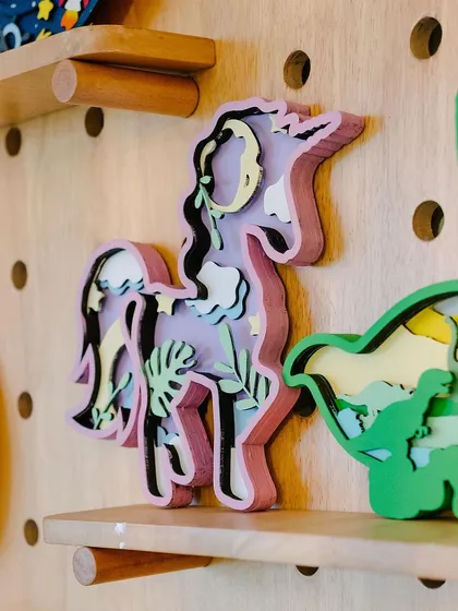 Another look at our inspiration wall, showcasing finished pieces like this magical unicorn and dinosaur. These displays give you an idea of all the wonderful things you can make here.