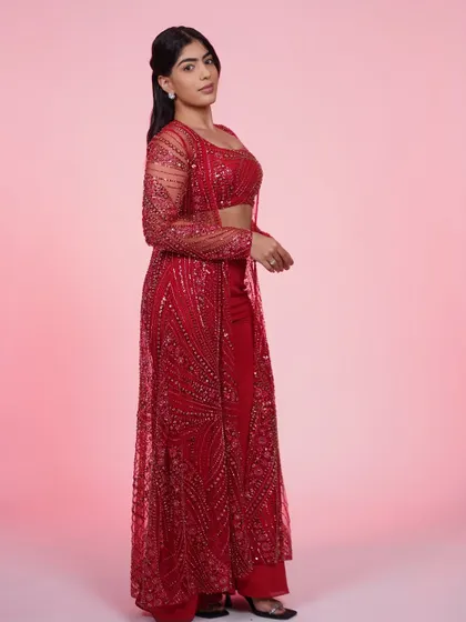 Another view of the red three-piece set, showing how the sheer jacket flows as you move. It's an outfit that's made for dancing.