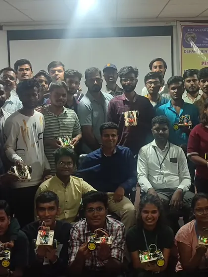 The graduating class of our one-day workshop, proudly holding the robots they built and programmed themselves.