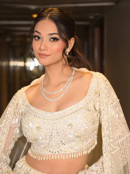 This close-up shows the beautiful harmony between the soft, glittery eye makeup and the intricate diamond jewelry. It's a look that feels both luxurious and effortlessly beautiful.