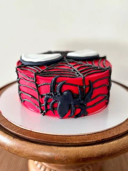 Your friendly neighborhood Spider-Man, in cake form! This is a mini cake, perfect for a small celebration, with the iconic web design piped in black.