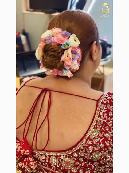 A full and vibrant floral bun perfect for a wedding ceremony. I used a variety of colorful artificial flowers to create a garden-like effect around this classic updo.